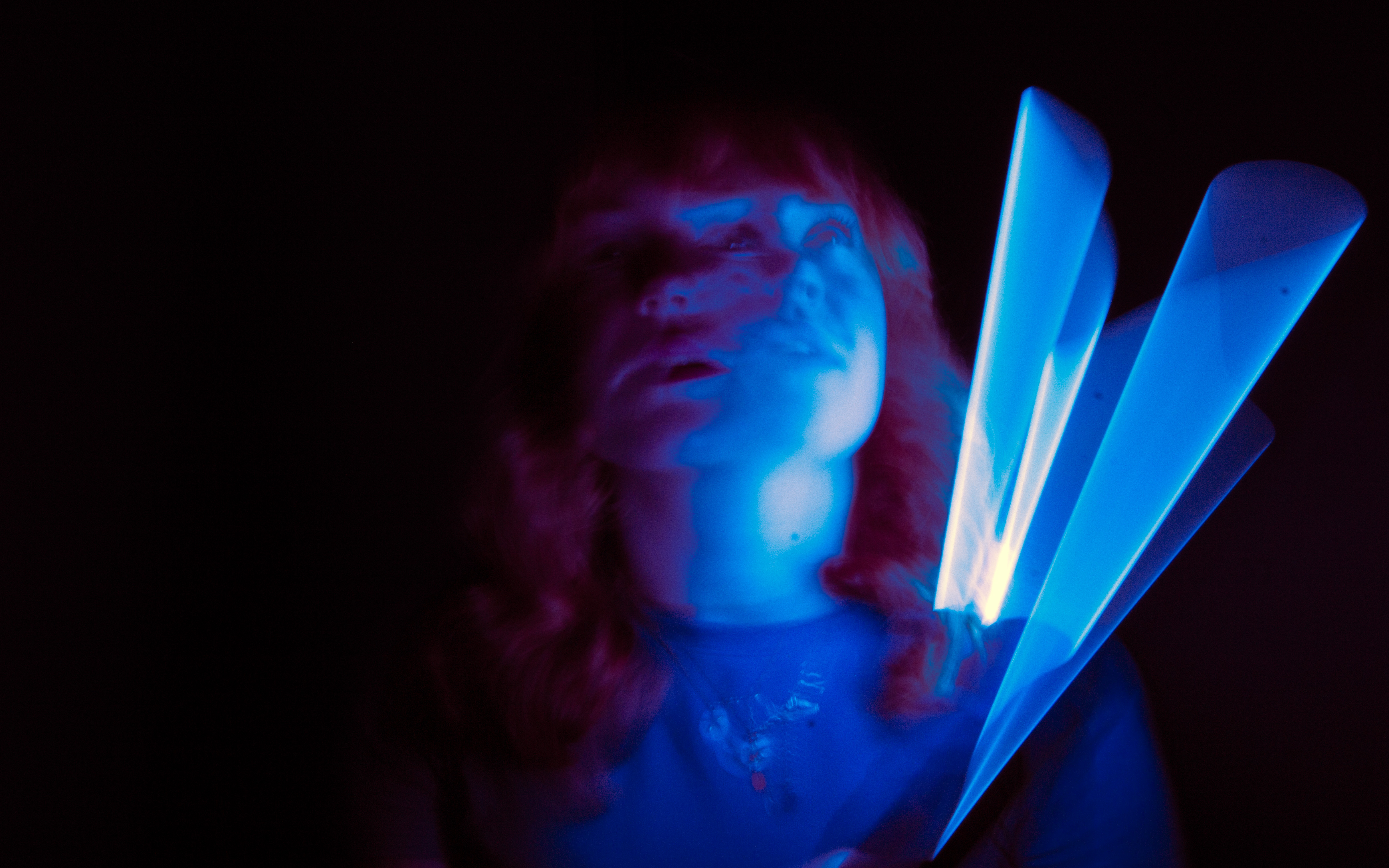 Portrait illuminated by blue light trails